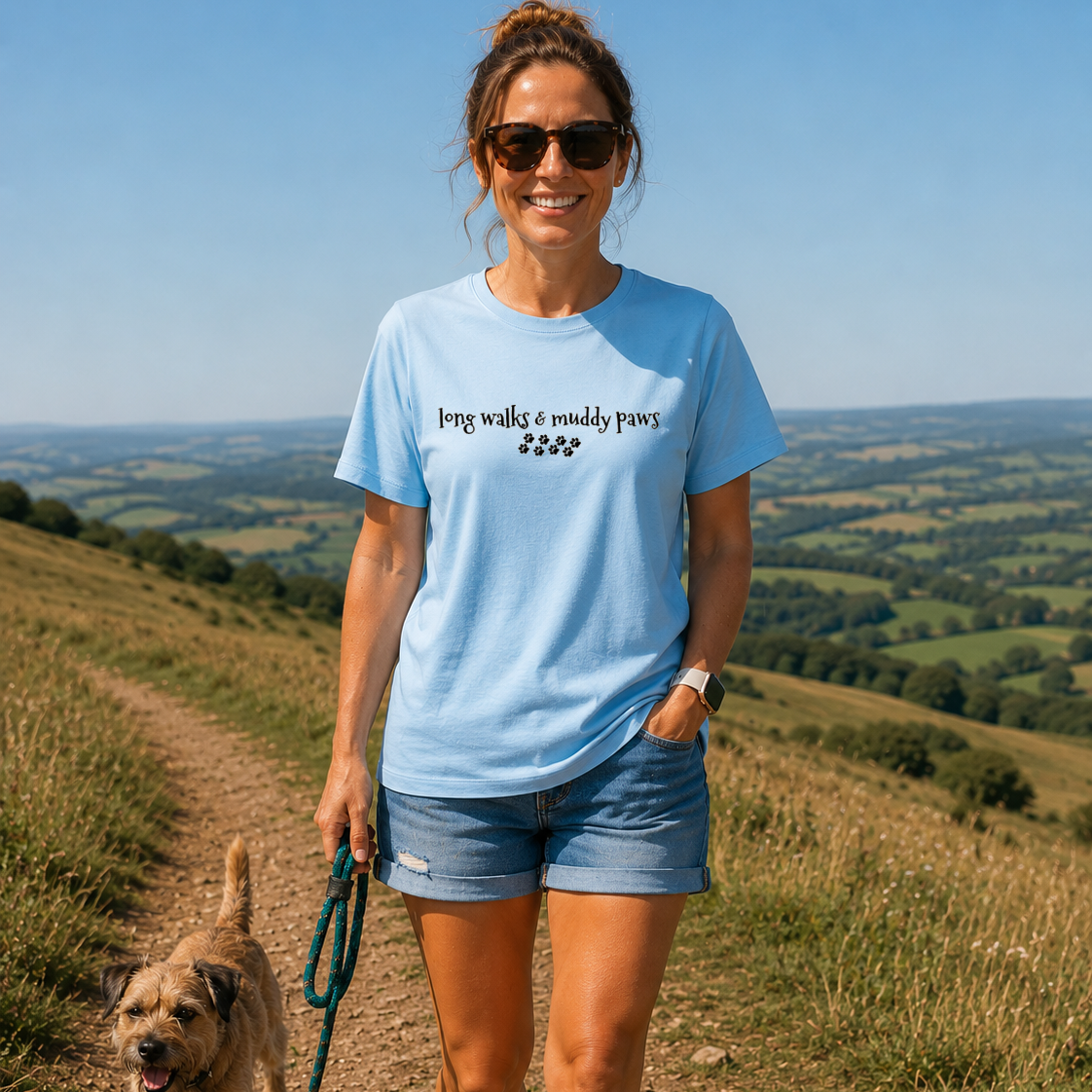 Woman walking a dog on a trail with a scenic landscape in the background