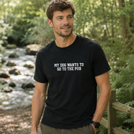 Man wearing a black t-shirt with text standing in a forest setting