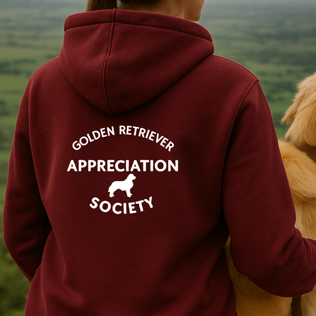 Person wearing a maroon hoodie with 'Golden Retriever Appreciation Society' text and a dog on a scenic background