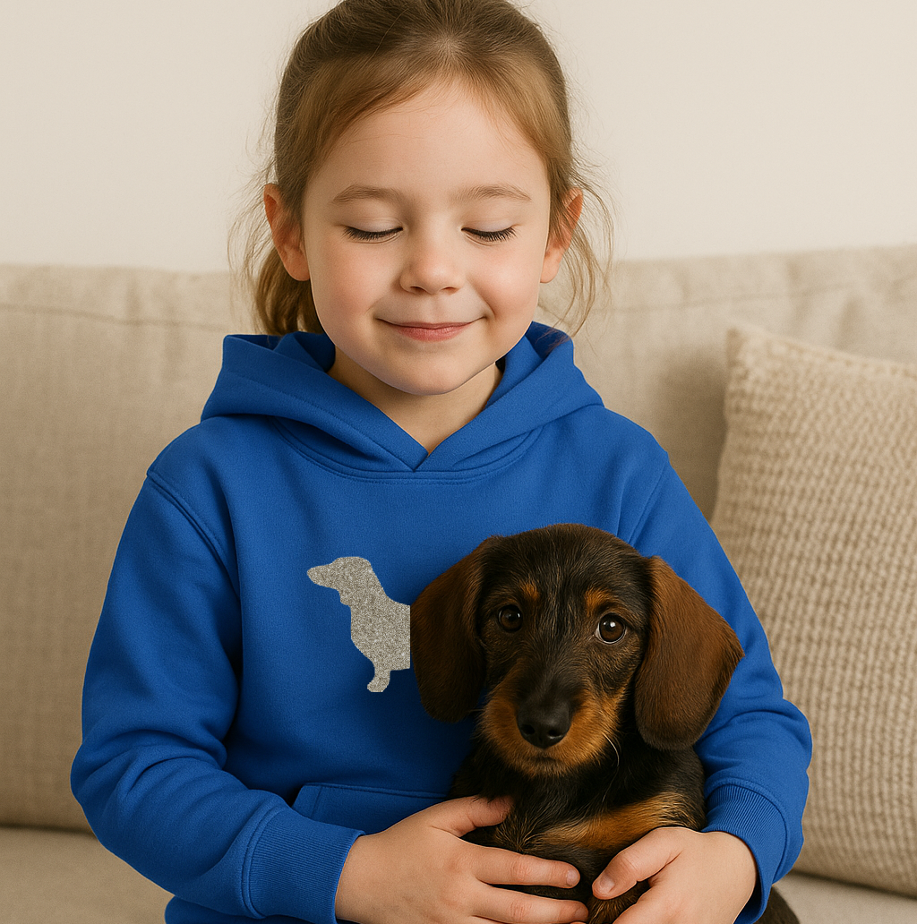 Child wearing a blue hoodie with a dachshund design, holding a small dog.