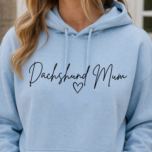 Light blue hoodie with 'Dachshund Mum' text and heart symbol on a blurred background