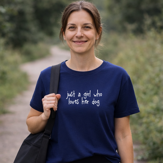Woman wearing a blue t-shirt with text, standing outdoors.